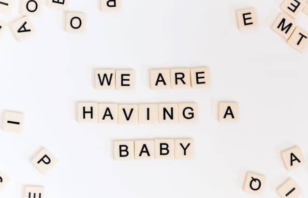 Scrabble tiles that state "we are having a baby"
